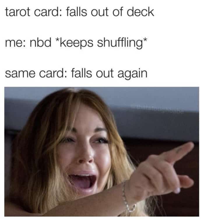 tarot card shuffling card falls out woman pointing